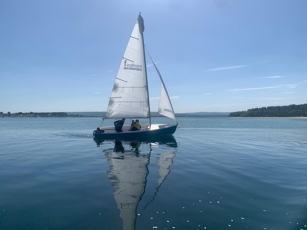 Small sailboat on calm blue water