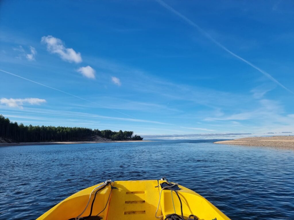 View from yellow boat on calm lake