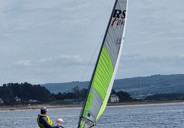 Person sailing on blue water in a small boat