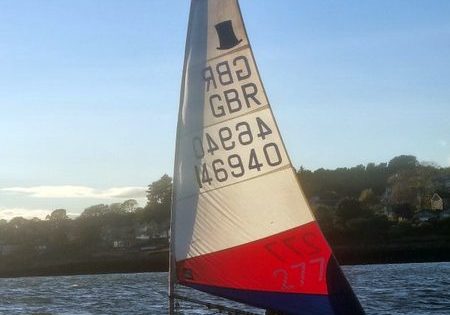 Sailboat racing at sunset, GBR flag on sail